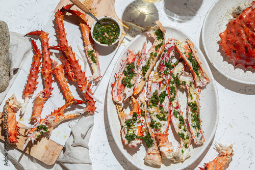 Delicious crab legs garnished with fresh herbs and garlic serve as the focal point of this mouth-watering dish. Paired with white wine.