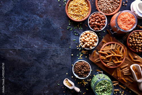 Selection of dried and canned legumes, and pasta made from legumes for plant-based whole food diet. photo