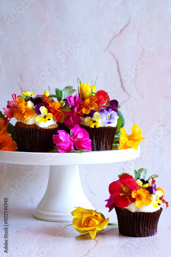 Japanese inspired carrot cupcakes with edible flowers, and negative space. photo