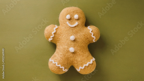 A fluffy, golden gingerbread man, crafted using needle felting technique and has soft and rounded shape, fastive background. photo