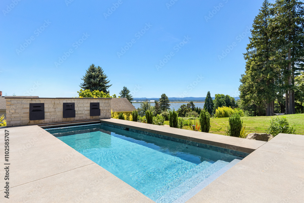 Outdoor pool in backyard of new luxury home Outdoor pool in backyard of new luxury home