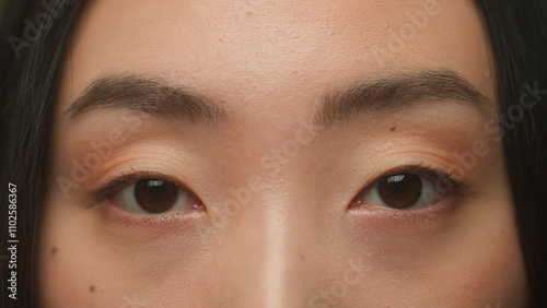 Macro extreme close up Asian woman female dark eyes face details korean japanese chinese girl model eyeball iris eye open eyesight gaze vision blink eyelashes skin care medical surgery beauty health photo