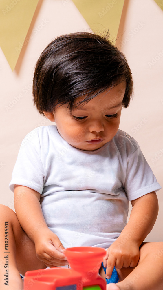 Excited toddler holding and playing with toys Excited toddler holding and playing with toys
