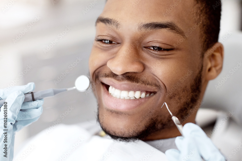 Dentistry Services Concept. Portrait Of Young Black Male Patient Sitting In Chair In Dental Clinic, Smiling Handsome African American Man Getting Treatment In Stomatological Cabinet, Closeup