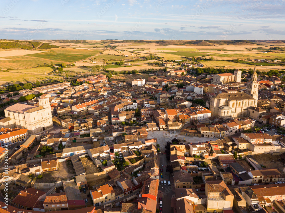 Fototapeta premium Scenic view from drone of Medina de Rioseco residential areas with medieval churches in sunny summer day
