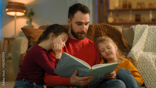 Obraz na płótnie Evening weekend home Caucasian family parent father read book little kids girls