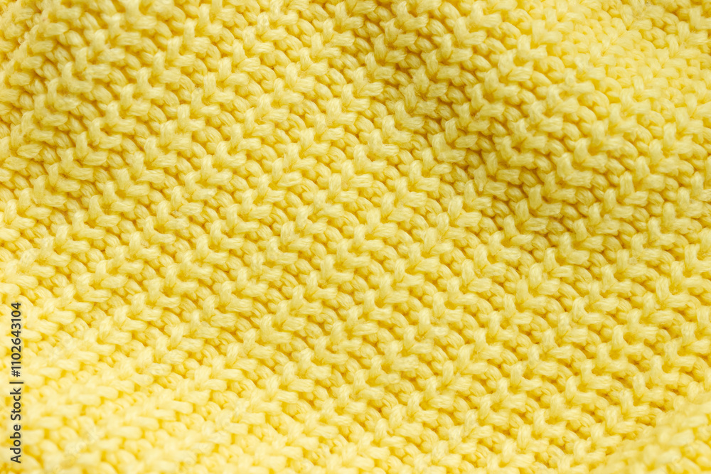 Texture of knitted lemon yellow pullover close-up placed diagonally. Selective soft focus, space for text Texture of knitted lemon yellow pullover close-up placed diagonally. Selective soft focus, space for text