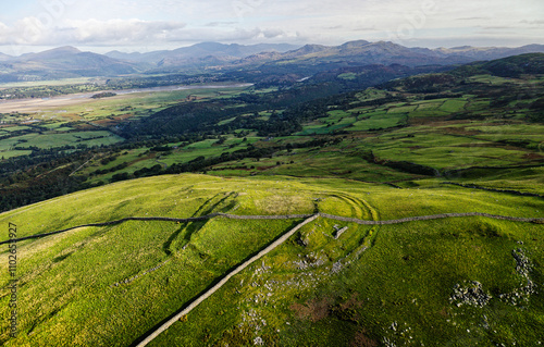 Obraz na płótnie Moel Goedog prehistoric hillfort Harlech, Wales. 2 concentric Bronze Age ramparts contain possible earlier enclosure. Aerial N. to Snowdonia mountains w salonie