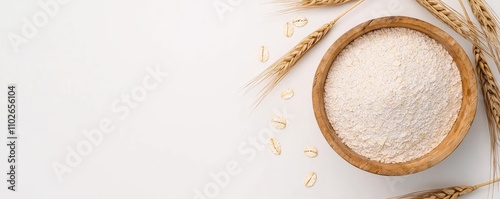 Flour in wooden bowl with wheat, white isolate background for culinary purposes. photo