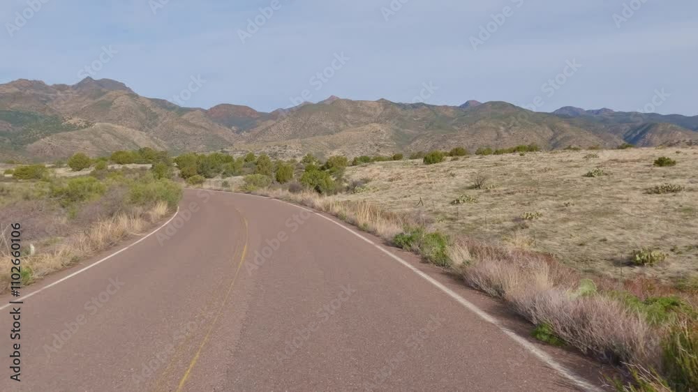 Drying Down an Isolated Desert Road with Mountains in the Distance Drying Down an Isolated Desert Road with Mountains in the Distance