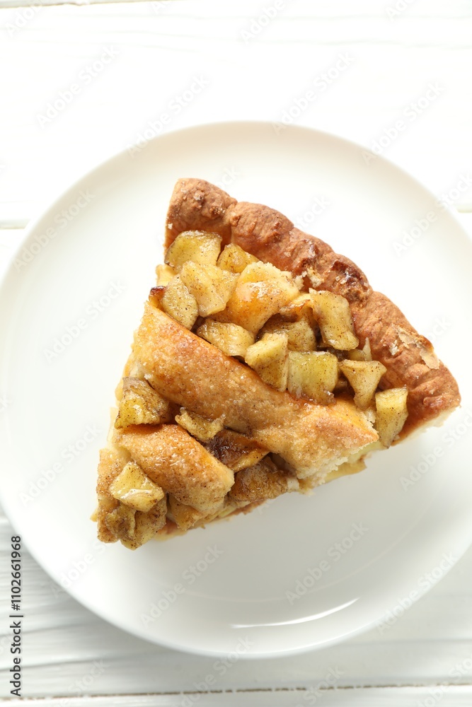 Slice of homemade apple pie on white wooden table, top view Slice of homemade apple pie on white wooden table, top view