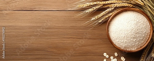 Bowl of flour with wheat grains on a wooden surface, rustic food preparation scene. photo