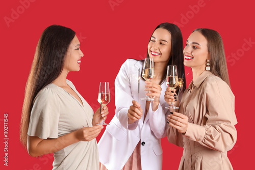 Three happy young women cel...