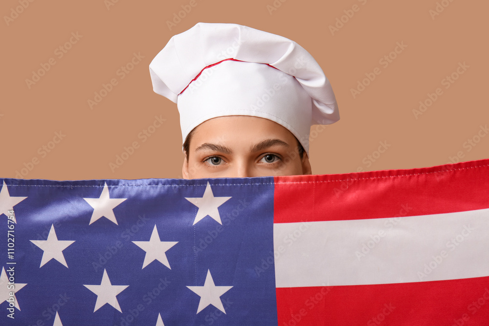 Female chef behind USA flag on beige background Female chef behind USA flag on beige background
