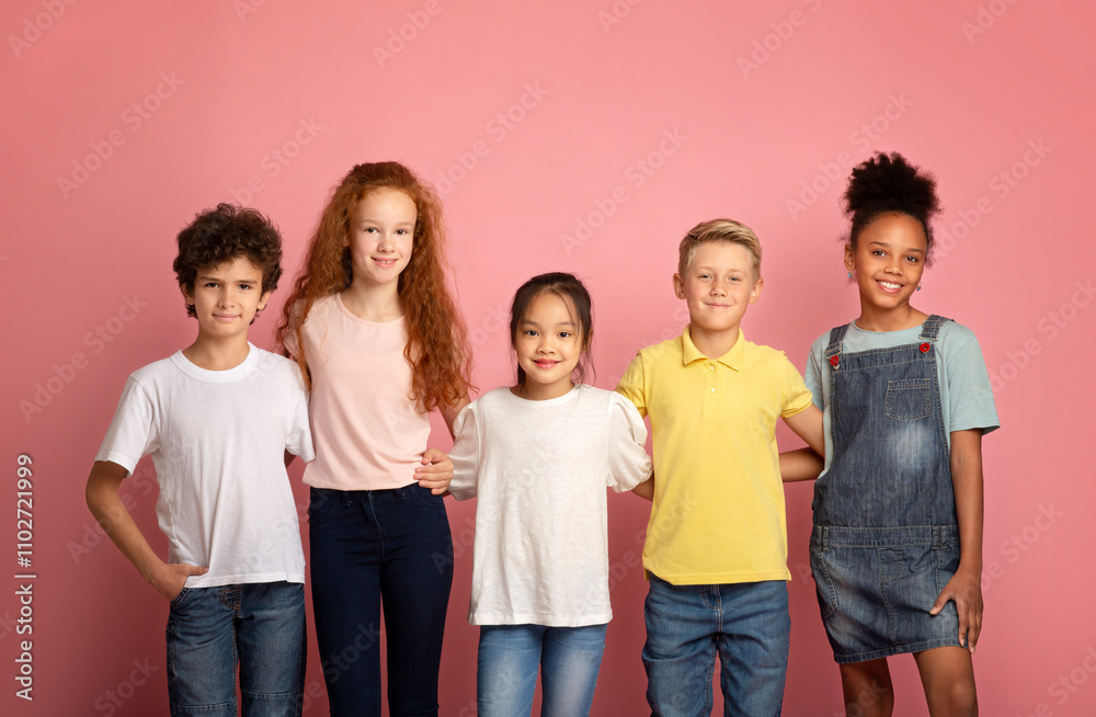 Back to school concept. Happy diverse boys and girls posing on pink background Back to school concept. Happy diverse boys and girls posing on pink background