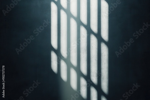 A ray of light casts shadows through a barred window, creating a stark contrast of light and dark in a moody environment.