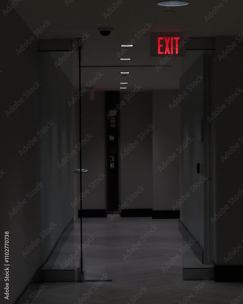 Exit Sign in a dimly lit hallway Exit Sign in a dimly lit hallway