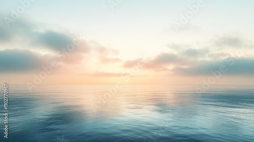 Serene ocean sunrise with calm water reflecting pastel sky and clouds.