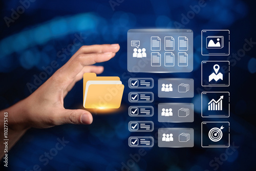 A hand holding a digital folder icon, with file management and data analysis icons in the background, symbolizing digital document organization and data processing. photo