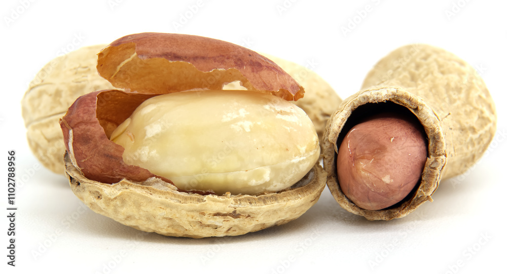 Close-Up of Whole and Shelled Peanuts on White Background Close-Up of Whole and Shelled Peanuts on White Background