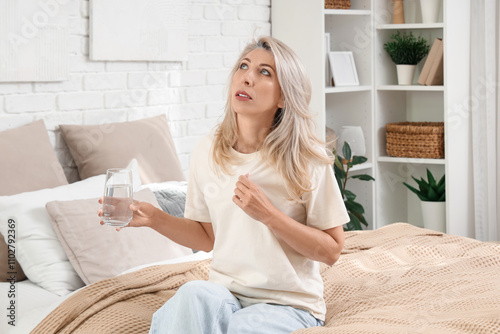 Mature woman with glass of ...