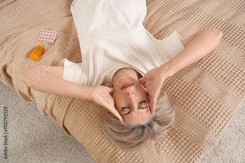 Mature woman with headache ...