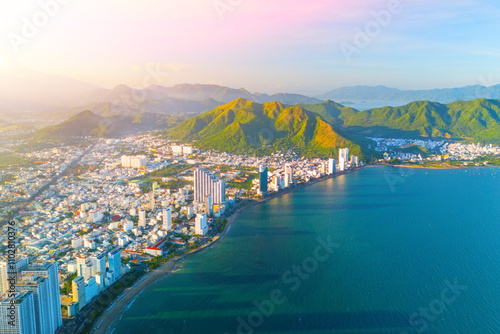 Schilderij op canvas Beach overlooking aerial view city on the coast of Southeast Asia in the evening