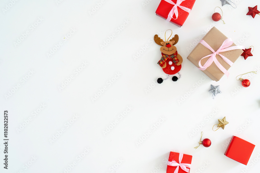 Minimalist Christmas gifts and reindeer ornament arrangement on white surface. Minimalist Christmas gifts and reindeer ornament arrangement on white surface.