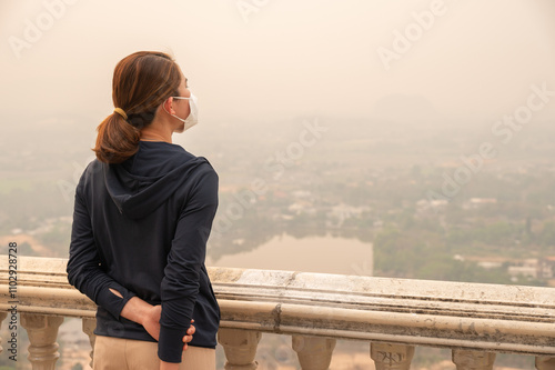 Rear view of Asian woman wearing an N95 mask for protect bad air pollution. photo