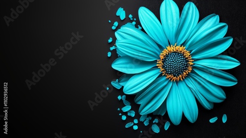A vibrant turquoise flower with petals scattered on a dark background. photo