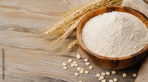 Bowl of flour with oats on rustic wooden table, natural ingredients.