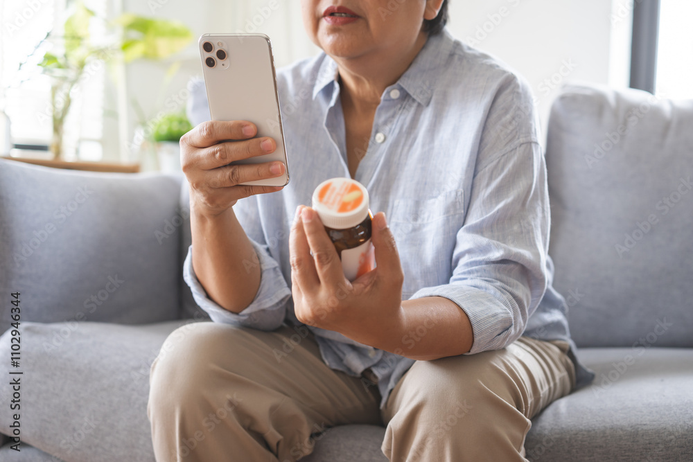 Health care concept, asian senior woman using smart phone reading, searching prescription on bottle medicine, pill label text about information online, instructions side effects, pharmacy medicament. Health care concept, asian senior woman using smart phone reading, searching prescription on bottle medicine, pill label text about information online, instructions side effects, pharmacy medicament.
