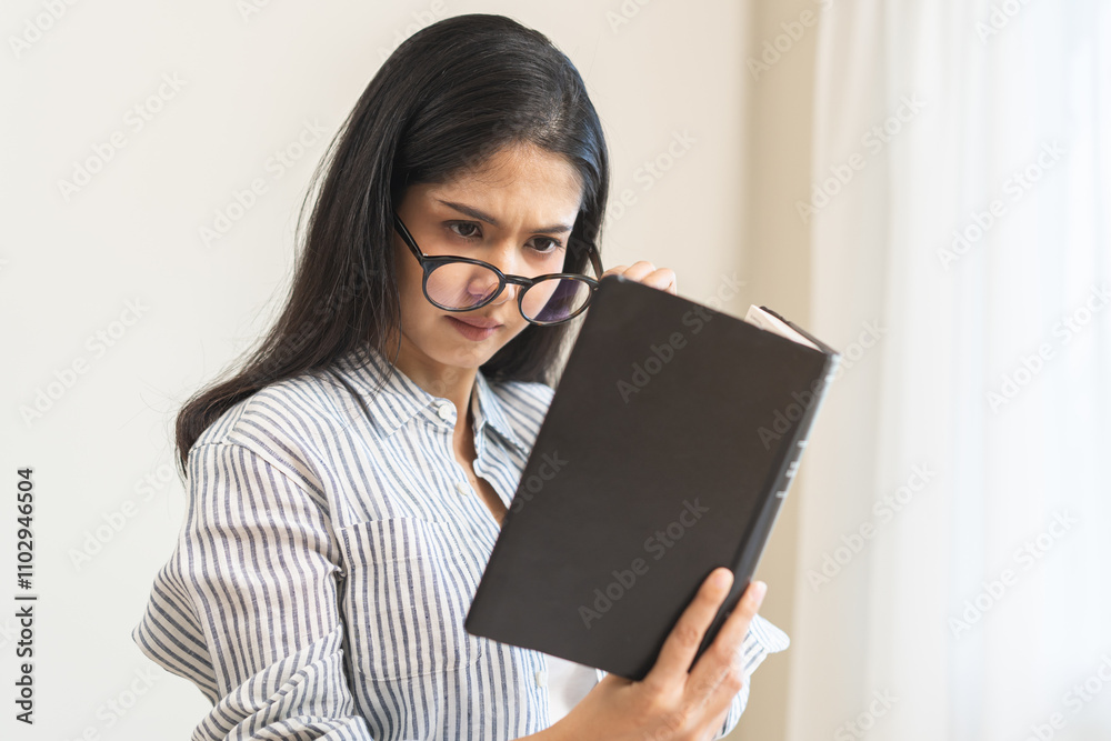 Presbyopia, hyperopia middle aged asian woman holding eyeglasses problem with vision blurred, female stare trying to read text on book at home, eye disease of old, eyesight farsightedness, health care Presbyopia, hyperopia middle aged asian woman holding eyeglasses problem with vision blurred, female stare trying to read text on book at home, eye disease of old, eyesight farsightedness, health care