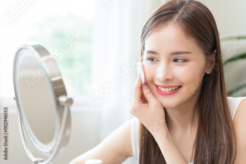 Remove makeup, attractive asian young woman, girl looking into mirror, hand holding cotton pad, apply facial wipe cleaning on her skin face, essence or lotion for treatment, skin care routine at home. Free Download Remove makeup, attractive asian young woman, girl looking into mirror, hand holding cotton pad, apply facial wipe cleaning on her skin face, essence or lotion for treatment, skin care routine at home. - GFXLoad