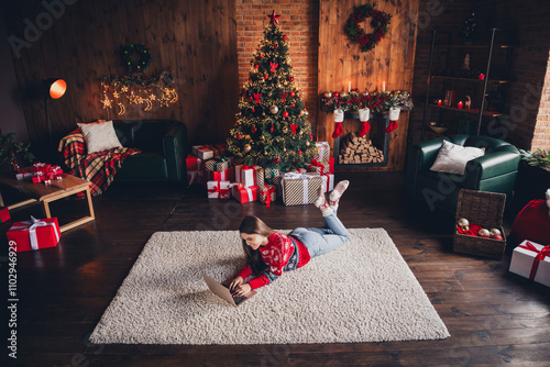 Photo of nnice pretty woman wear new red clothes lying on carpet enjoying christmas festive time weekend decorated room indoors photo