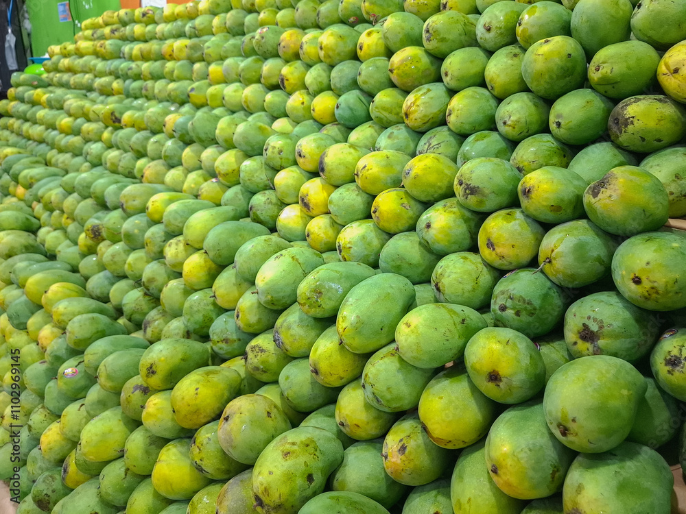 background with piles of mangoes on display and for sale background with piles of mangoes on display and for sale