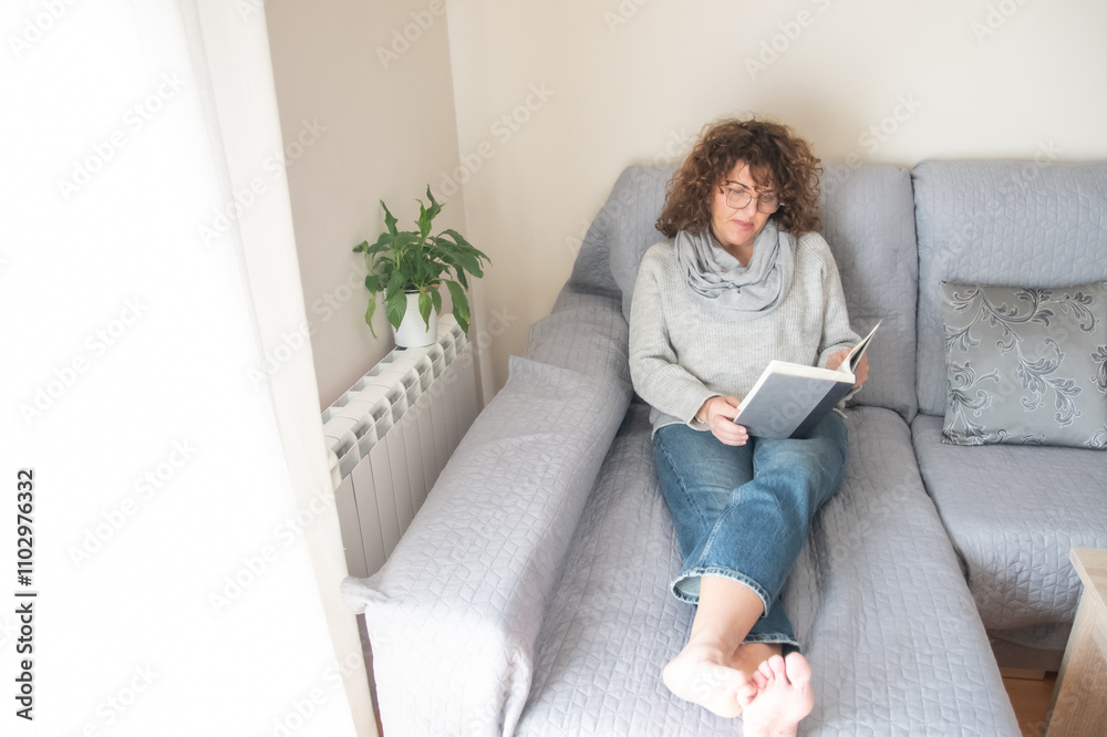 Relaxed Lady Reading A Book In A Cozy Room With Natural Decor, Promoting Ideas Of Self-Improvement, Learning, Relaxation, Indoor Lifestyle, And Enjoying Peaceful Moments At Home Relaxed Lady Reading A Book In A Cozy Room With Natural Decor, Promoting Ideas Of Self-Improvement, Learning, Relaxation, Indoor Lifestyle, And Enjoying Peaceful Moments At Home