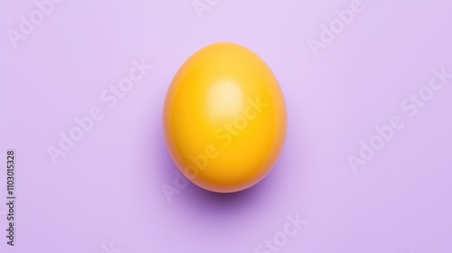 Vibrant yellow egg yolk centered on soft purple background elegant top view shot for culinary or artistic presentations photo