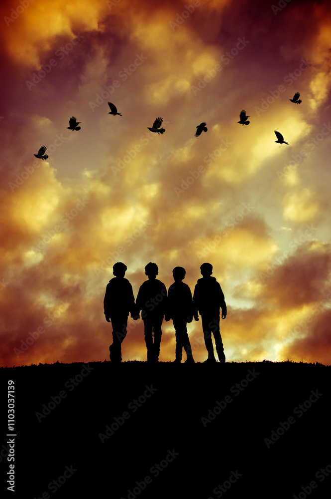 four boys in silhouette standing ona ridge at sunset four boys in silhouette standing ona ridge at sunset
