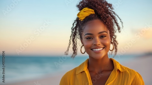 A joyful woman with a yellow hair accessory stands smiling near the beach waves, reflecting the essence of summer and carefree moments.