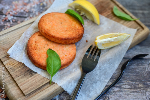  Fishburger.Homemade ketogenic  Salmon Burger with Tartar Sauce and  whole grain ketgenic bread. Healty  low carb high protein food photo