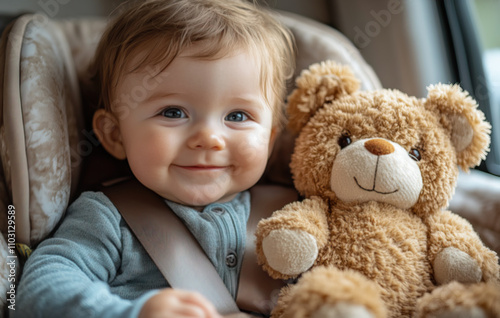 Happy baby sitting in a car seat with a stuffed animal, smiling photo