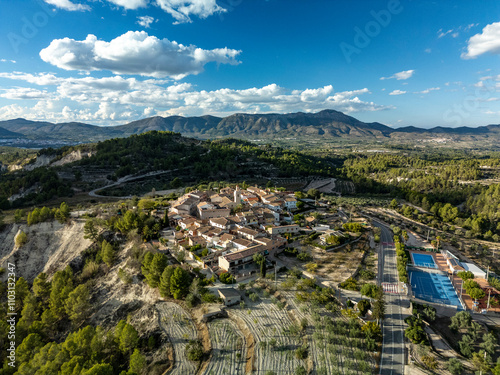 Benillup village aerial skyline at sunset,  Drone point of view with Benicadell mountain background, Alicante, Costa Blanca, Spain photo