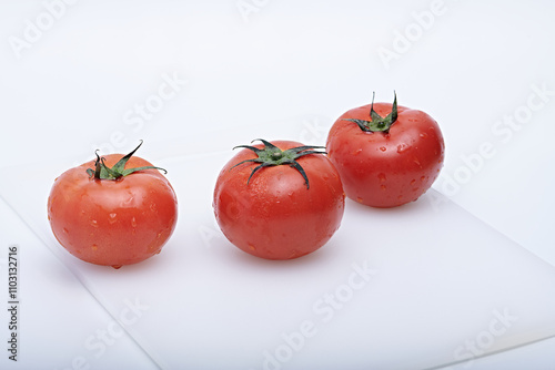 Fresh red tomatoes healthy vegetables photographed on white background and mat photo