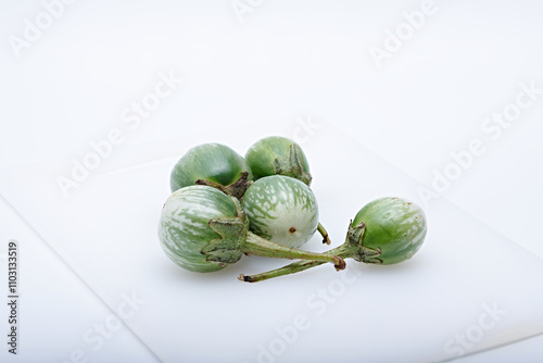 Fresh round green mini eggplant healthy vegetable photographed with white base and background