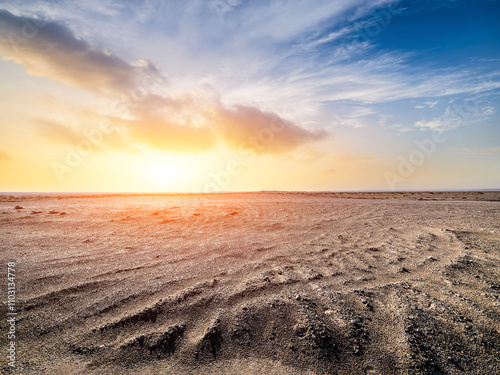 Fototapeta Naklejka Na Ścianę i Meble -  Desert sand ground and sky clouds at sunset. Outdoor natural background.