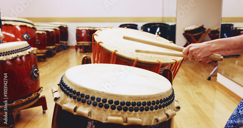 Japanese, drums or hands of person in practice for music on instrument for stage performance, creativity or talent. Taiko, stick or drummer in studio to play in rehearsal for culture, rhythm and beat photo