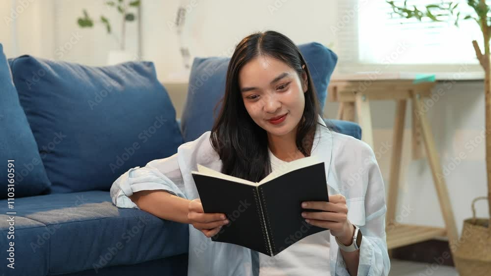 Confident beautiful asian woman using smartphone, laptop for work in living room at home with sofa to sit and read book relax during working time. Technology concept. Holiday. Confident beautiful asian woman using smartphone, laptop for work in living room at home with sofa to sit and read book relax during working time. Technology concept. Holiday.