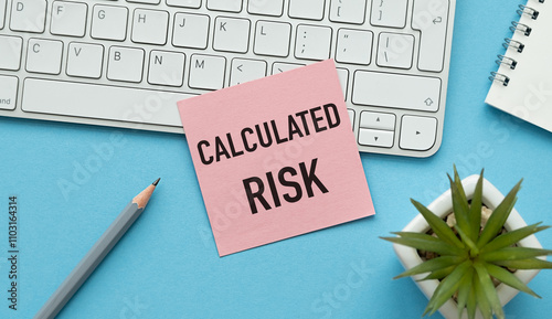 Calculated Risk text on pink card clip to a sheet of paper on the blue table photo