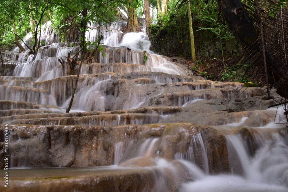 Obraz premium Travel to waterfalls during the rainy season, The tiers of the waterfall contrast beautifully with the sky, Nature itself is the best physician